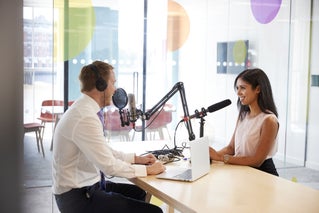Podcast host interviewing person