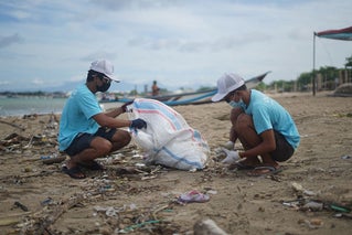 people cleaning up beach