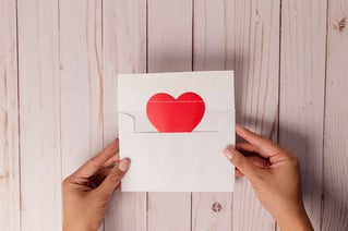 opening envelope with heart on letter inside