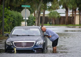 car driving through flood waters