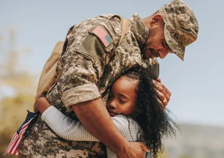 veteran hugging child