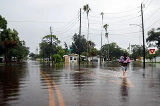 man walking through water