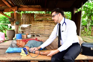 doctor helping elderly woman