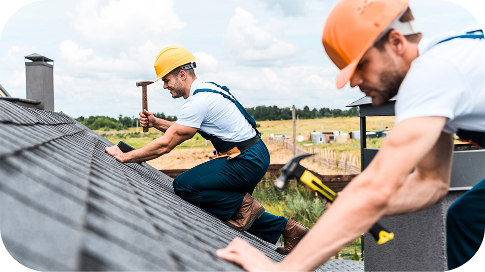 Roofers installing shingles